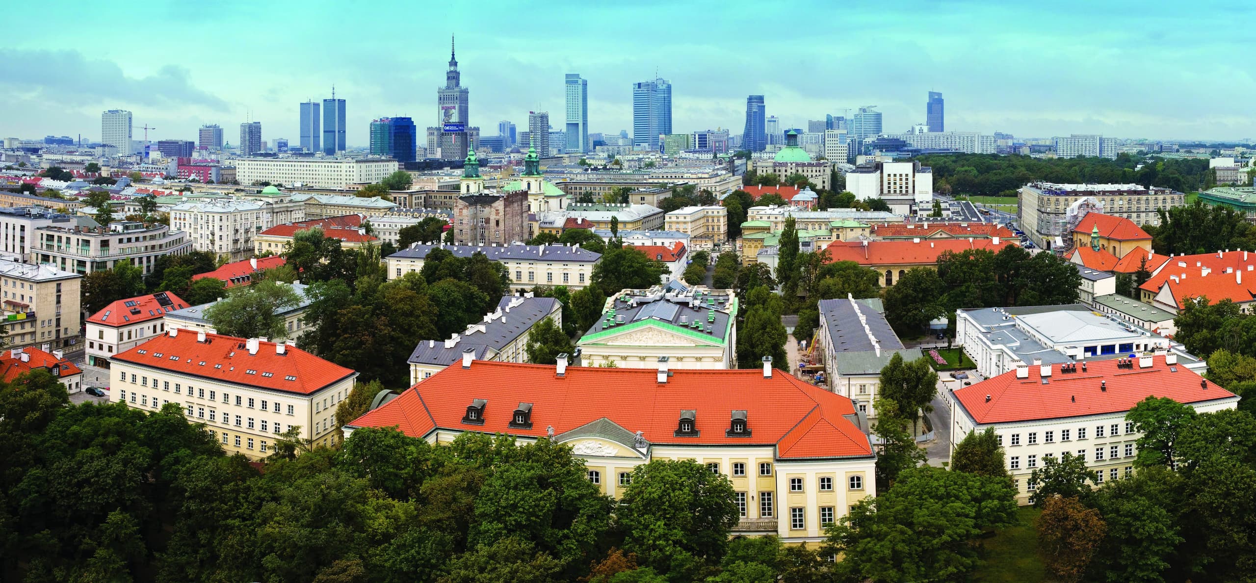 Aerial view of the University of Warsaw campus with the Warsaw skyline behind